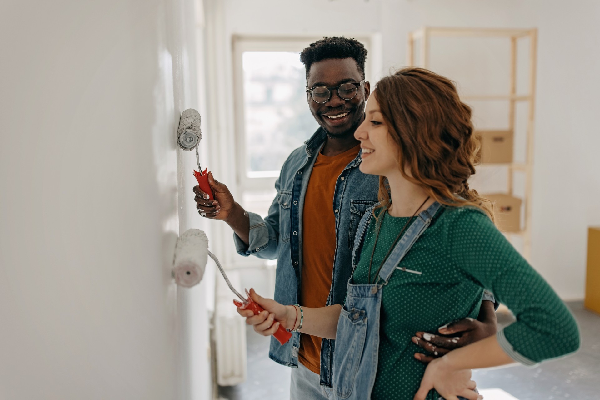 Young  couple painting walls