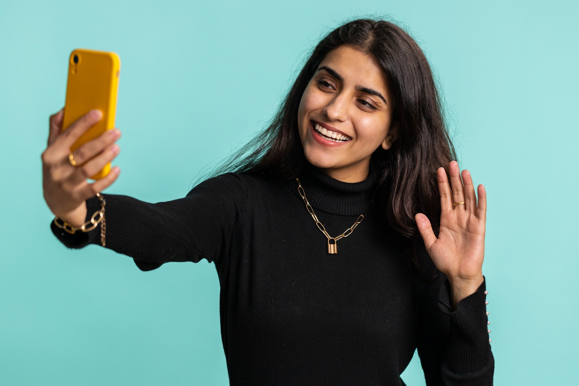 Indian woman traveler blogger taking selfie on smartphone communicating video call online stream